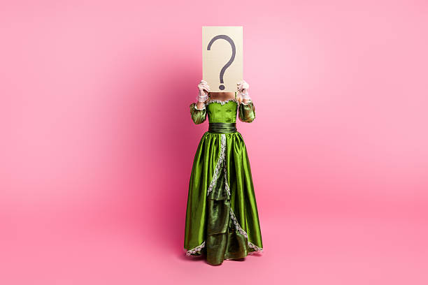 Elegant lady in a green dress hiding face with a question mark sign, against a pink background A woman in a luxurious retro green gown holds a question mark sign against a vibrant pink background. Perfect for concepts of identity, contrast between eras, and vintage themes. aristocrat woman photos stock pictures, royalty-free photos & images