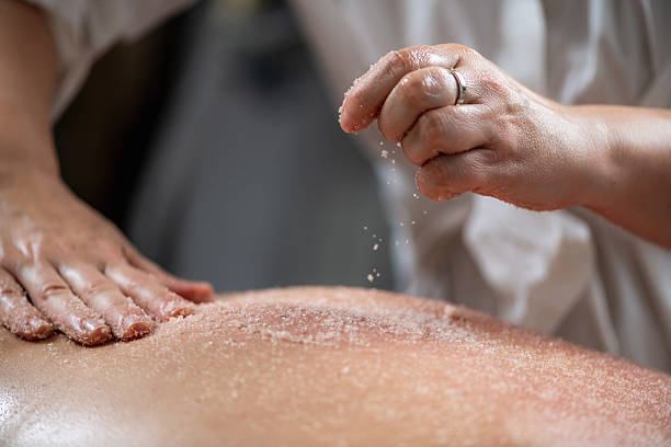 istock Back scrub massage with exfoliating salts combines relaxation and skin revitalization, relieving muscle tension while leaving the skin smooth and rejuvenated in a serene spa setting 2206000280