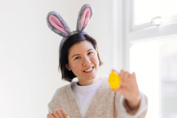 istock Happy young woman is holding Easter eggs 2206000871