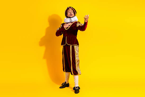 istock Young nobleman in historical attire performing dramatically, contrasted with vibrant yellow modern background 2206001321