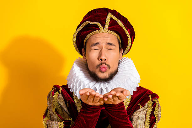 istock Medieval nobleman in traditional attire making amusing gesture against bright yellow backdrop 2206001359