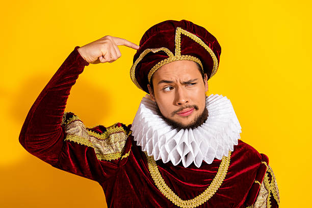 istock Young man dressed as a classic nobleman gestures questioningly in front of a bright yellow background 2206001362