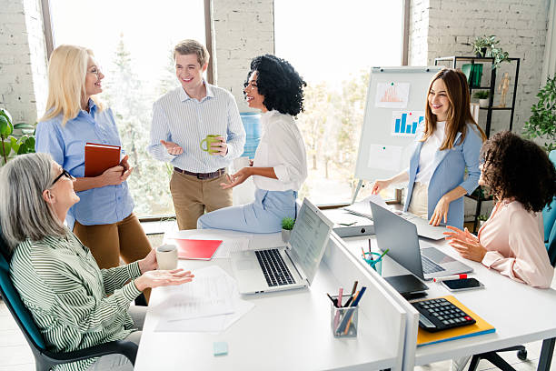 istock Group of professionals collaborating in a modern bright office setting during the day 2206001783