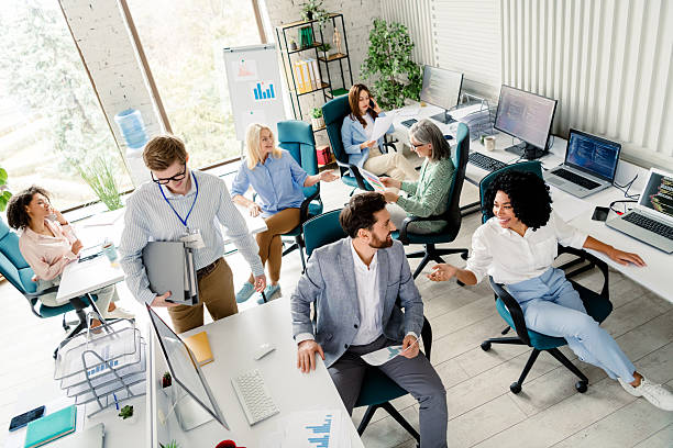 istock Modern office scene featuring diverse professionals collaborating and working together during a sunny day 2206001806