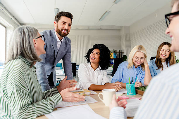 istock Diverse group of professionals collaborating in an office setting during a daylight meeting, fostering teamwork 2206001830