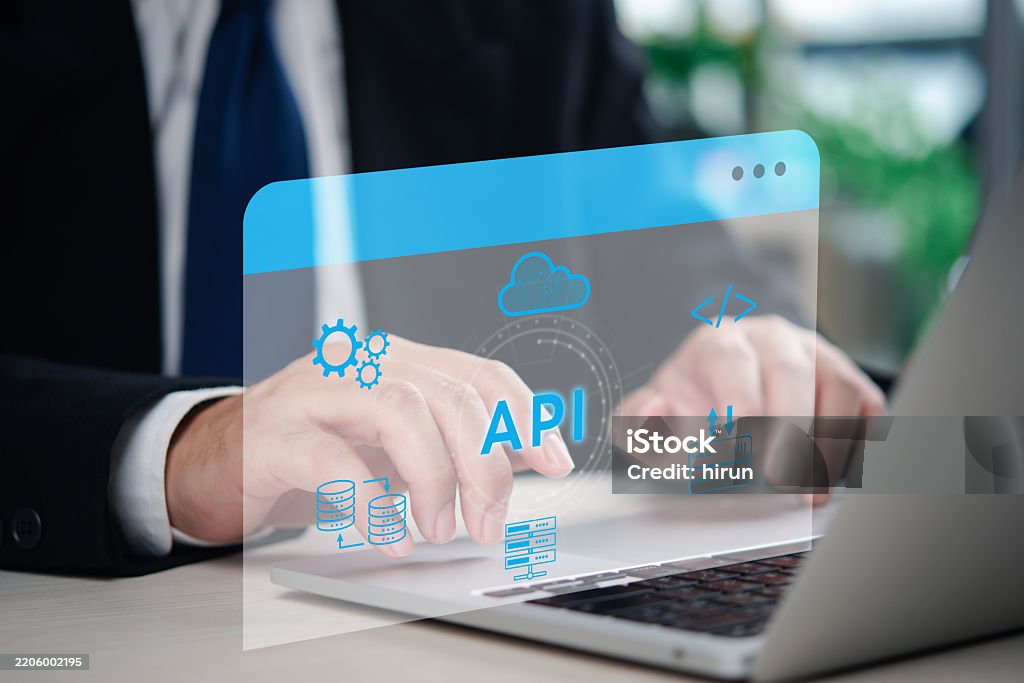 A software developer working on an API integration project with database and cloud services, demonstrating digital transformation in IT. Programming code and cloud computing visual elements. Application Form Stock Photo A software developer working on an API integration project with database and cloud services, demonstrating digital transformation in IT. Programming code and cloud computing visual elements. Application Form Stock Photo