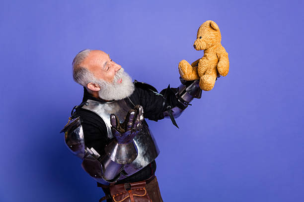 istock Armored man holding teddy bear humorously evokes medieval and modern contrasts 2206003825