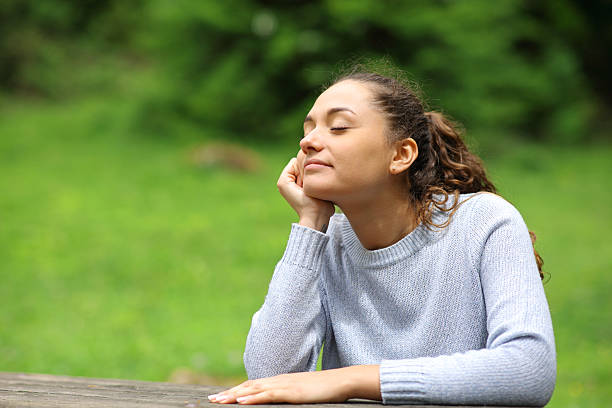 istock Woman relaxing with closed eyes in nature 2206004111
