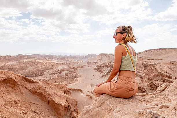 istock Woman Relaxing on Rock in Desert Landscape 2206007201