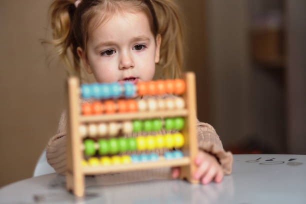 istock Cute girl playing whit abacus toy 2206009639
