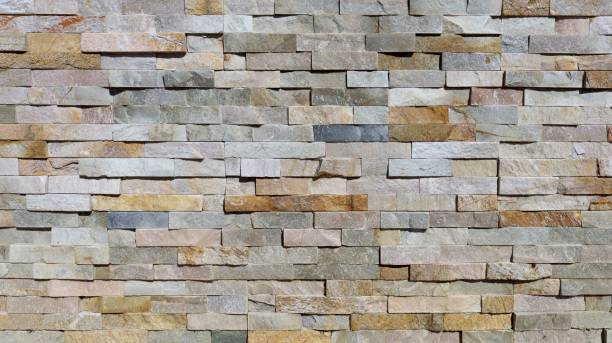 istock External stone coating wall made of  multicolor rocks bricks. 2206010631