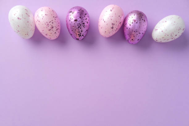 istock Speckled Easter eggs in pastel shades on a purple background. Minimalism style. Flat lay, top view. 2206011435