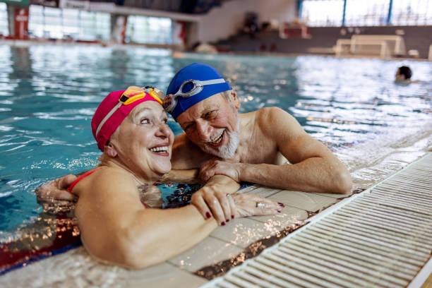 istock Elderly Couple Sharing a Joyful Moment While Swimming in Indoor Pool 2206015954