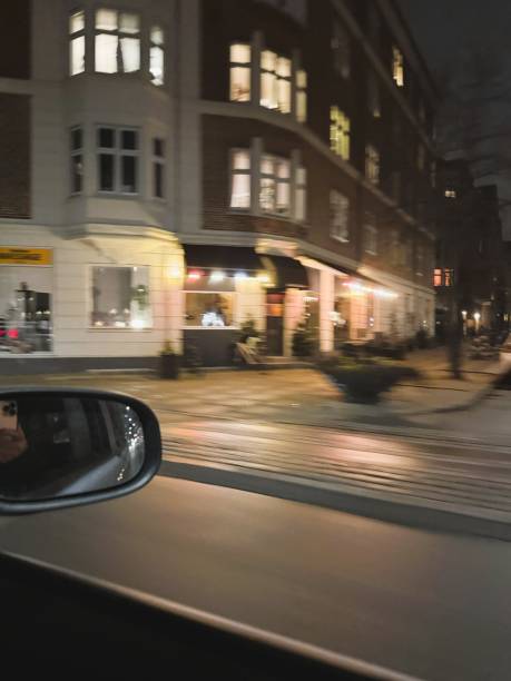 A dynamic and atmospheric shot capturing the essence of a nighttime drive through the streets of Copenhagen. The blurred motion of city lights and passing vehicles creates a sense of speed and urban energy, highlighting the vibrant nightlife and modern cityscape. Perfect for themes of travel, transportation, and city life.