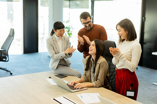 istock Team celebrates success together in a bright modern office environment 2206019317