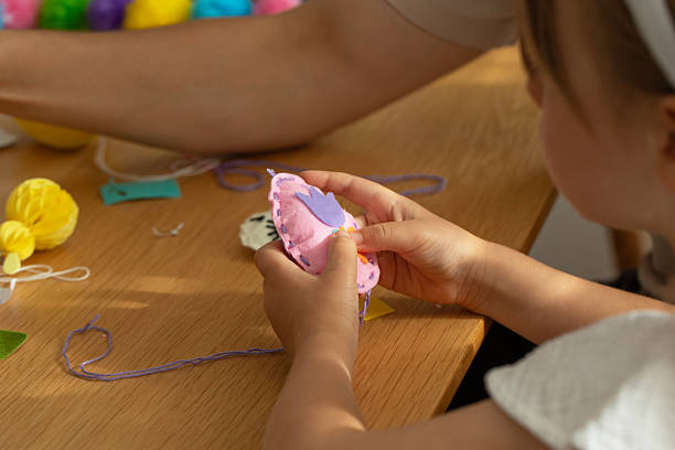 istock Dad helps daughter make a toy with her own hands. diy 2206021343