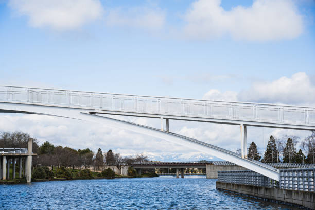 istock White metal bridge over the lake 2206022782
