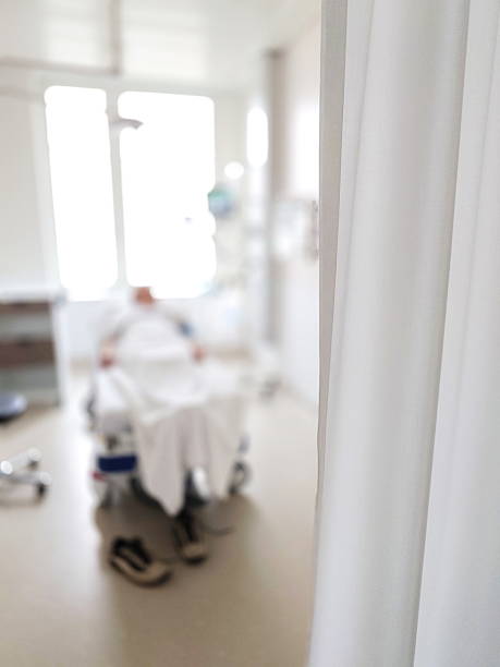 istock Blurred, unrecognizable patient on a hospital bed inside recovery room. Natural window light 2206023760
