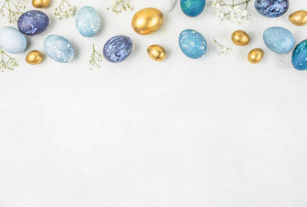 istock Festive Easter background. Easter eggs and flowers decorated on a light background. top view. copy space 2206023844