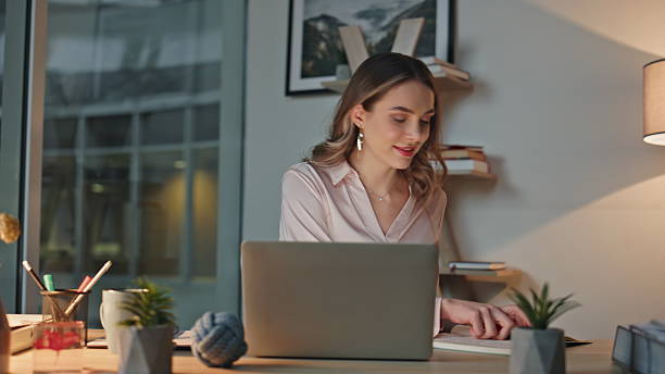 istock Late businesswoman taking notes working in office. Smiling professional planning 2206025807