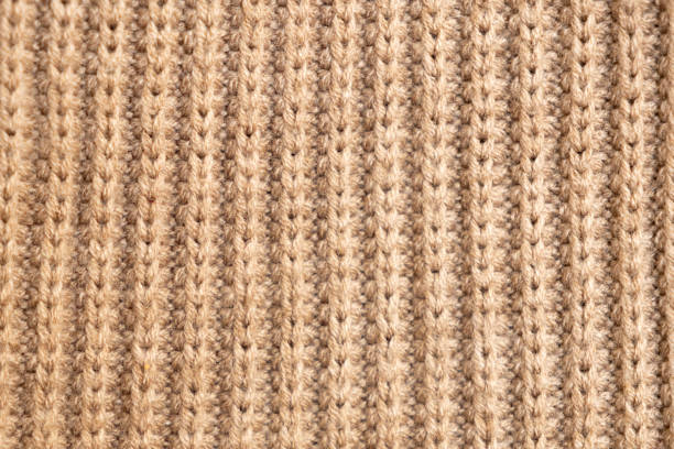 istock knitted texture, beige sweater or carpet. English elastic band pattern. industrial knitting. 2206026960