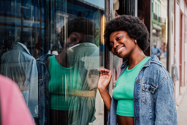 istock Young woman looking for store window 2206029206