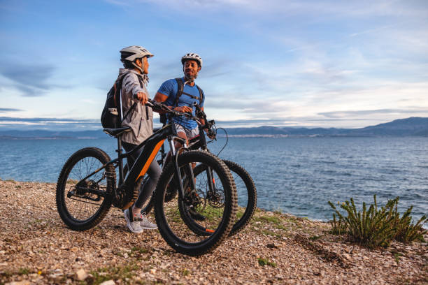 istock Two Cyclists Enjoying Scenic Coastal Ride at Sunset 2206031334