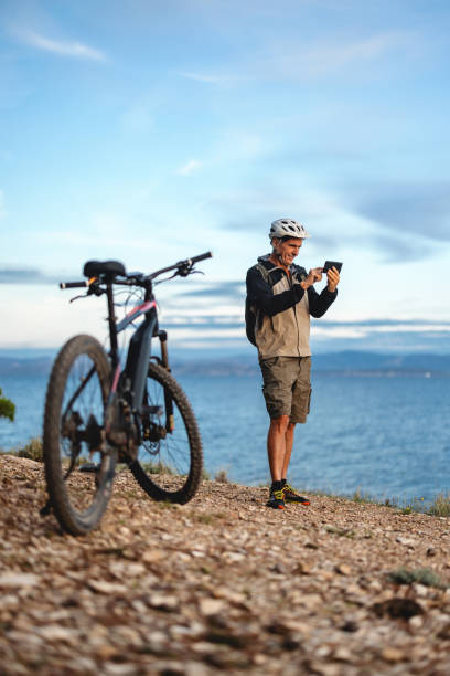 istock Mature Cyclist Enjoys Coastal Mountain Biking Adventure 2206031338