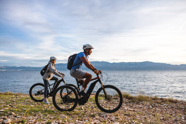 istock Couple Mountain Biking by the Ocean 2206031352