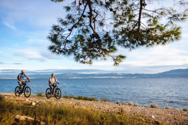 istock Two Men Cycling by the Sea on Mountain Bikes 2206031353