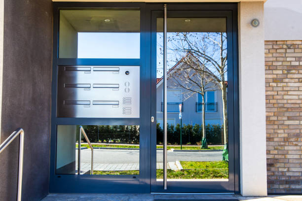 istock Anthracite-coloured front door with glass and intercom system on an apartment building 2206031912