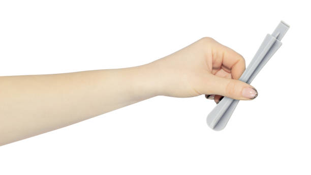istock plastic spatula for disassembling the case of phones and laptops in hand, outstretched hand with plastic spatula isolated from background 2206033210