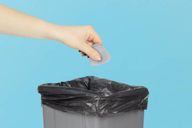 istock throw mediator for disassembling phones and laptops into trash can, mediator in hand in front of trash can, plastic recycling concept 2206033359