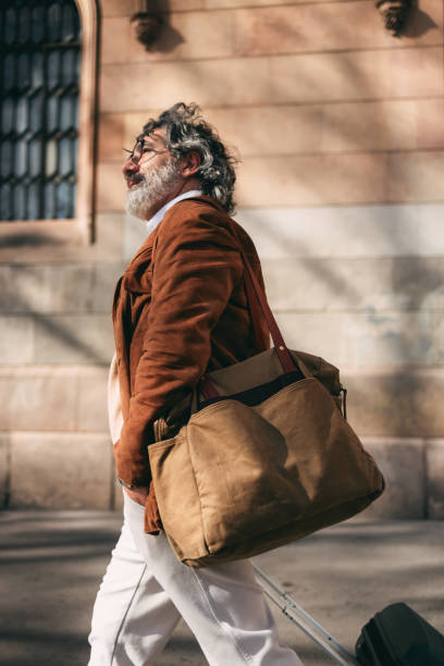 istock Man Walking Outdoors With Bag Wearing Stylish Jacket 2206033811
