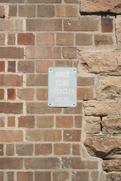istock Hoses using recycled water sign on a brick wall 2206034169