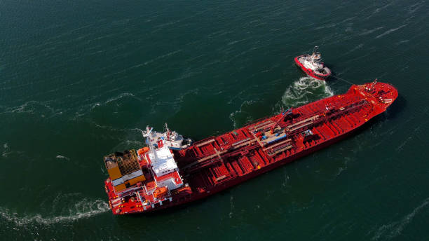 istock Aerial view of a container ship pushing from a small boat, Liquid cargo ship docked at the port, Unloading and loading of containers from the ship in the port 2206035153
