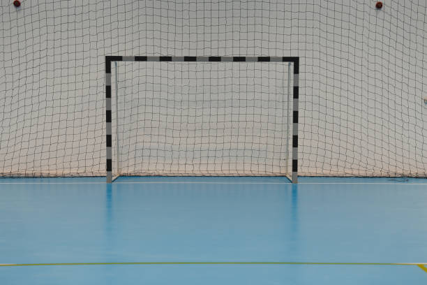 istock Empty handball goal on a blue epoxy floor in a sports hall 2206035449