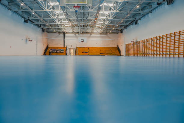 istock Empty sports hall reflecting on the shiny epoxy floor 2206035454