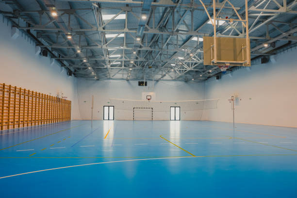 istock Empty sports hall with blue epoxy floor and volleyball net 2206035517
