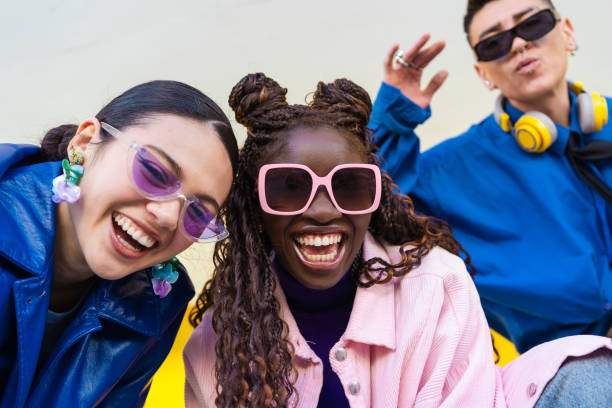 istock Young friends bonding, sharing laughter, expressing individual style through trendy casual clothing while hanging out together 2206037444