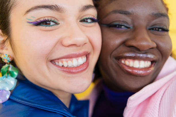 istock Close-up portrait featuring two diverse young women, beaming with joy and displaying their radiant smiles and perfect teeth 2206037536