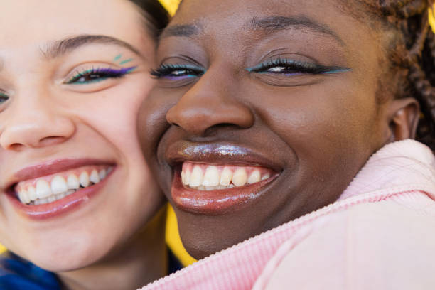 istock Cheerful young women hugging, sharing genuine warmth and happiness while smiling together 2206037540