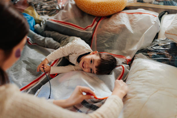 istock Mother and son playing with clothes storage bags 2206039870