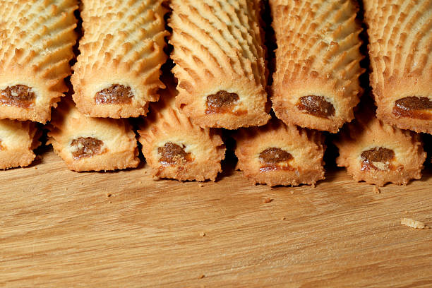 Delicious baked treats lined up on wooden surface