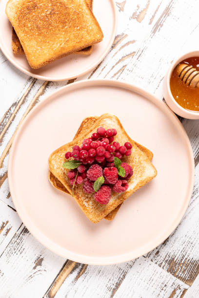 istock Toast with frozen raspberries and red currants 2206040035