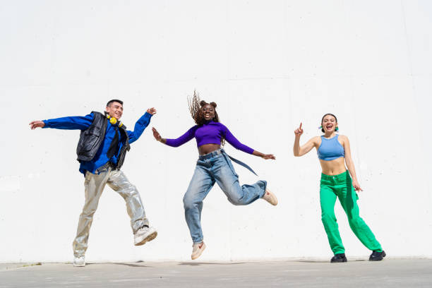 istock Multiethnic dancers leaping high, expressing dynamic energy through vibrant costumes and shared celebratory motion 2206040251