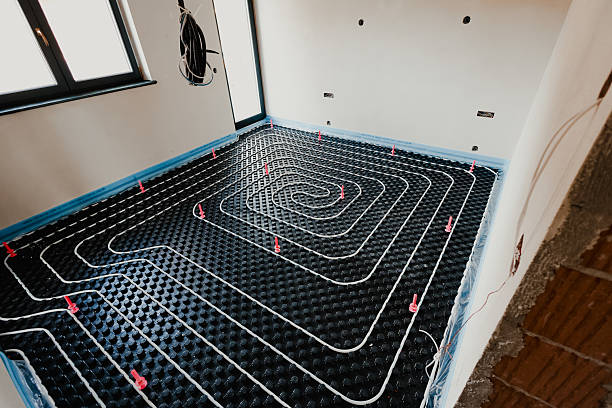 istock Installing underfloor heating system in new house with insulation panels and pipes 2206040553