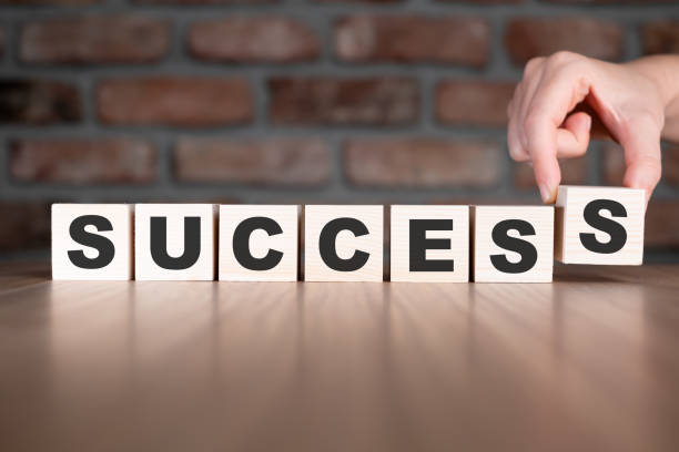 istock Success word with wooden blocks on table 2206042308