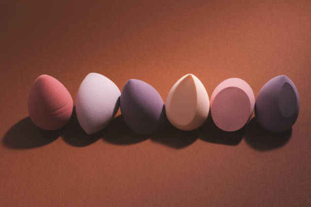 istock Makeup sponges arranged in a row on brown background. 2206042534