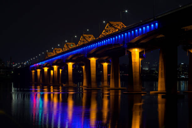istock low-angle view of the illuminated bridge on Han River in the night 2206043034